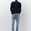 Jeans a zampa con effetto schizzi di vernice