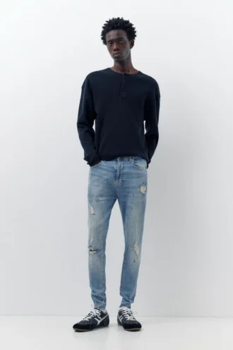 Jeans a zampa con effetto schizzi di vernice