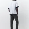 Jeans a zampa con effetto schizzi di vernice