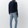 Jeans a zampa con effetto schizzi di vernice