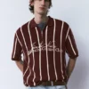 Polo in maglia a righe con cerniera Polo in maglia a righe con cerniera