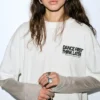 T-shirt a maniche doppie con slogan T-shirt a maniche doppie con slogan