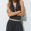 Top all’americana con dettagli metallici Top all’americana con dettagli metallici